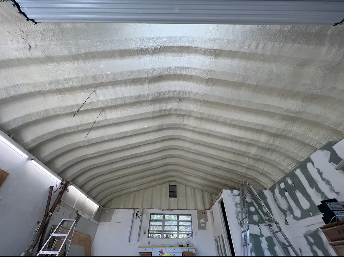 Spray polyurethane foam applied to the underside of a metal roof deck in Bemiss